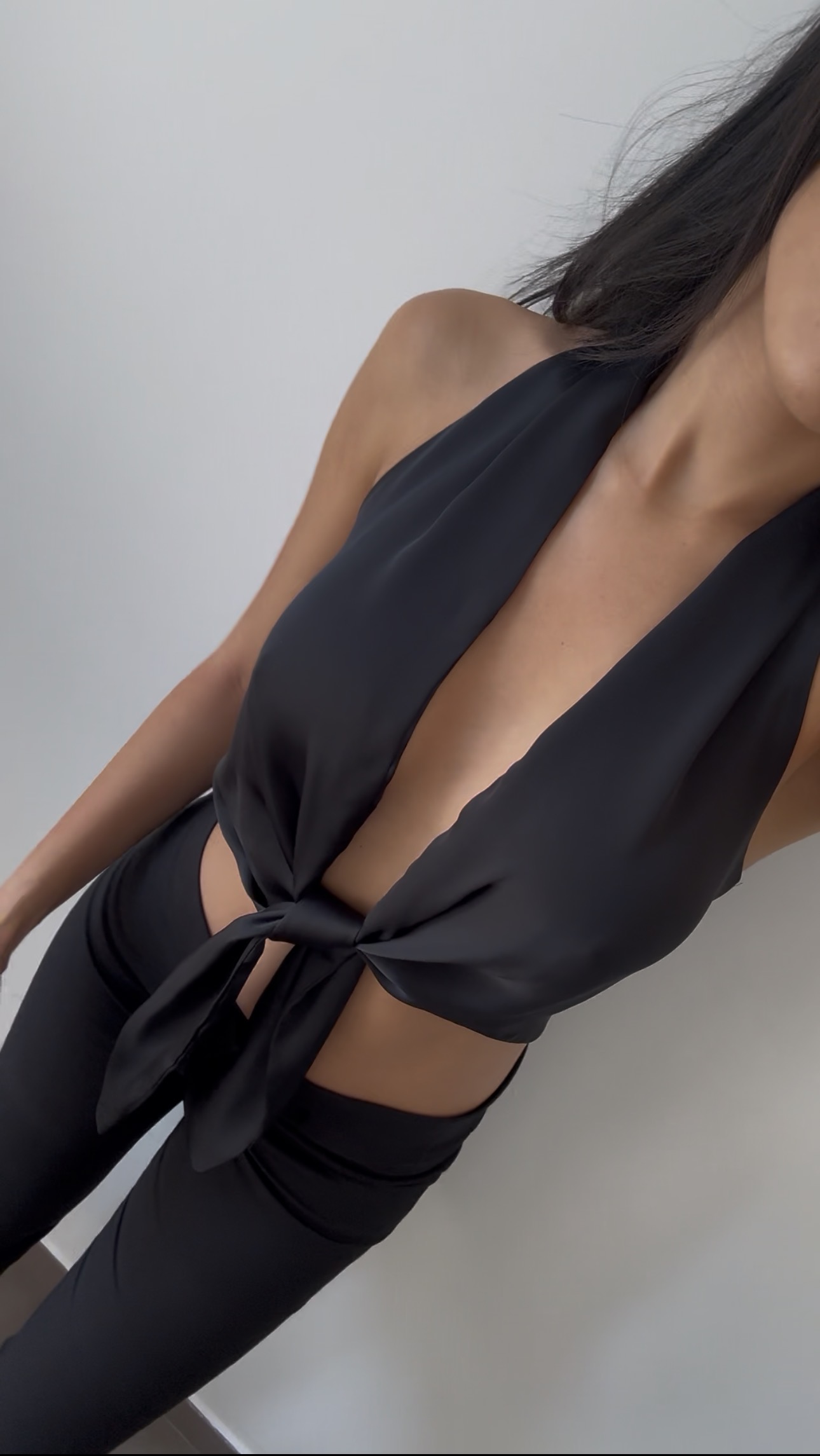 Black halter top with plunging neckline and front tie made using the Gabrielle Top sewing pattern.